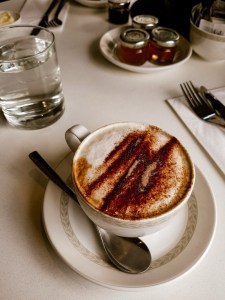 Picture of a table setting with a cup of coffee and a glass of water 